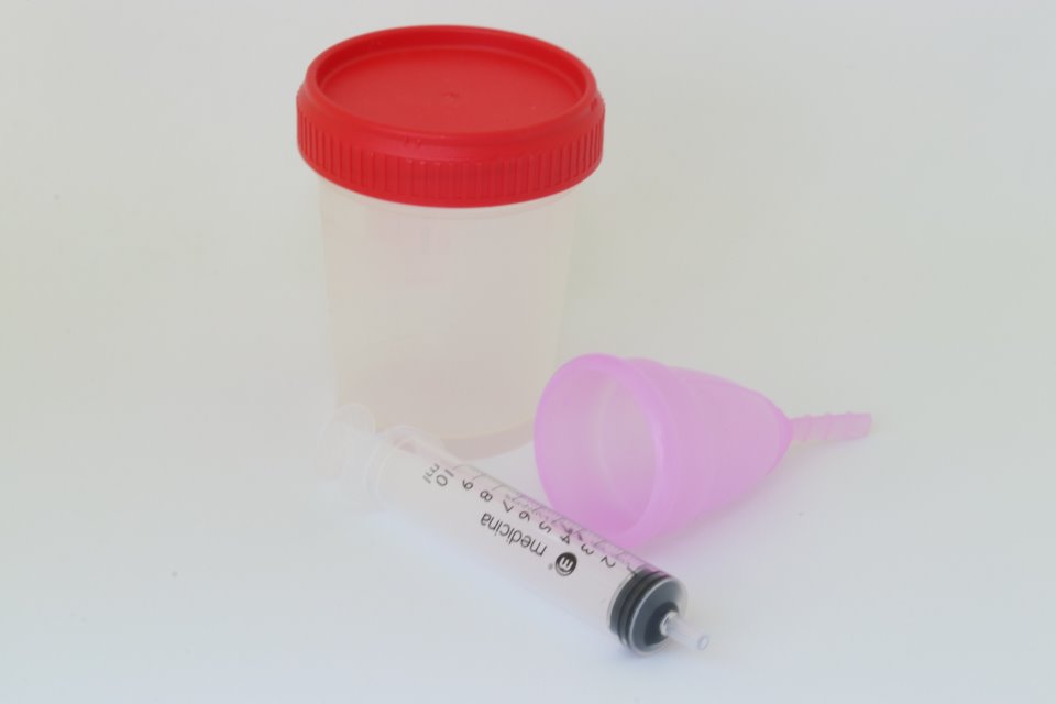 A home insemination kit featuring specimen cup, fertility cup and syringe