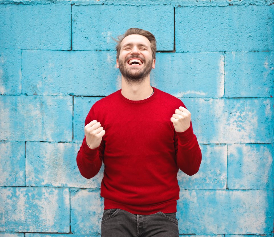 man pumping fists happy