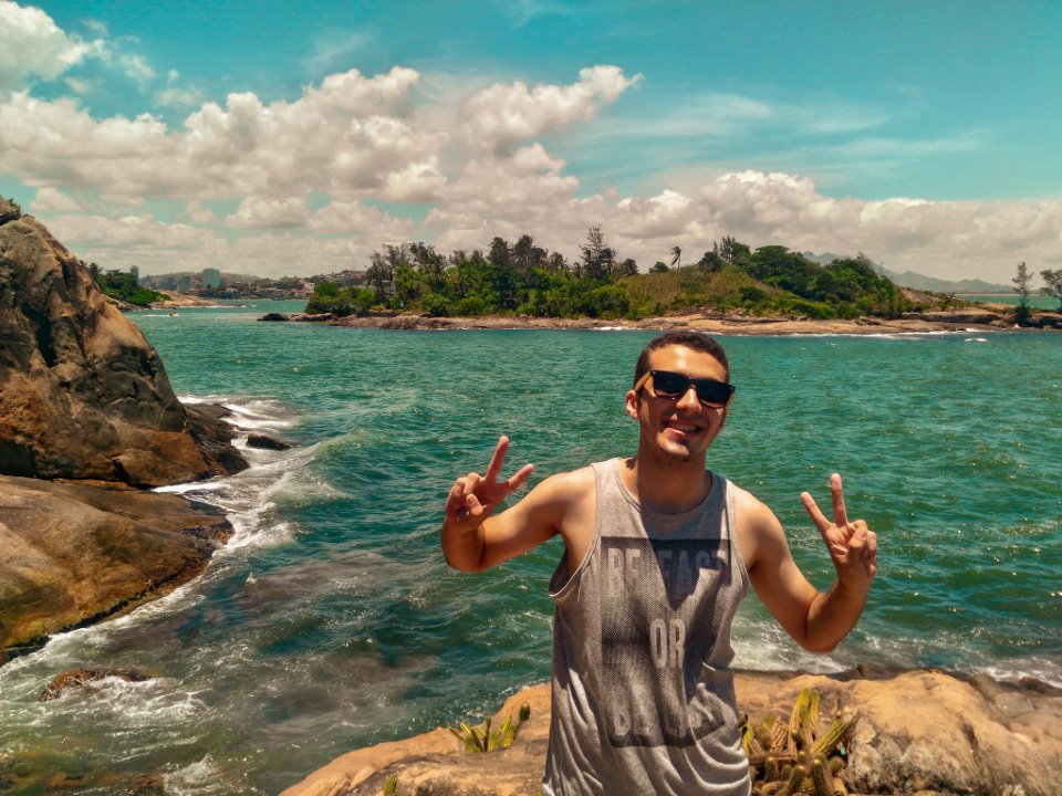 man smiling by beach