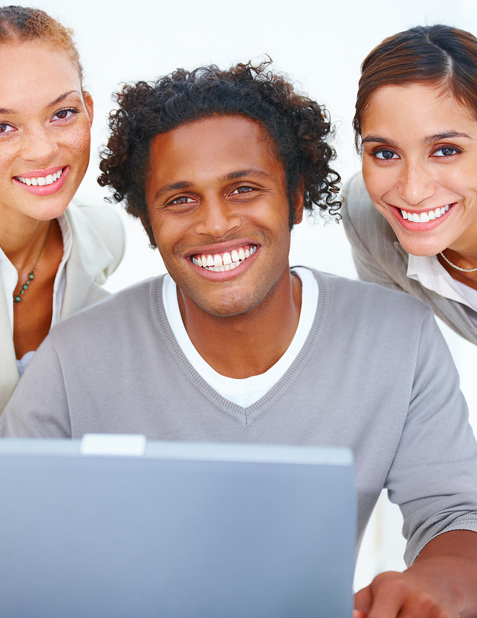 two women talking to man on laptop