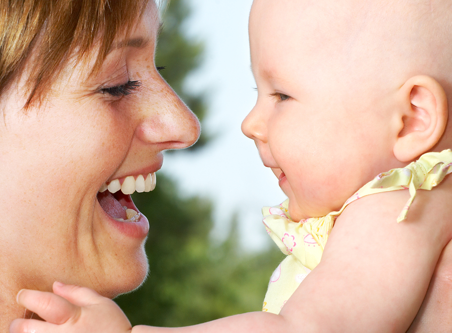 Woman smiling at baby