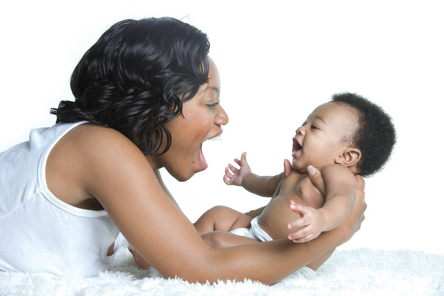 A woman smiling at her baby