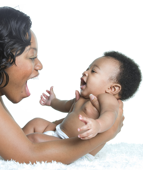 Black woman looking at her baby