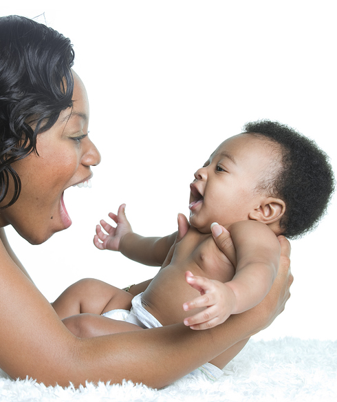 woman looking at smiling baby