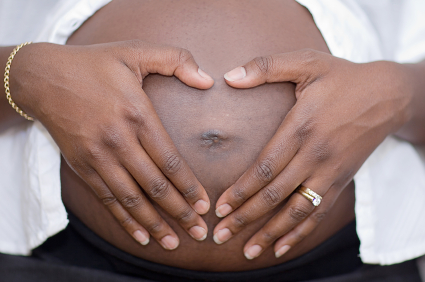 Pregnant belly with hands on