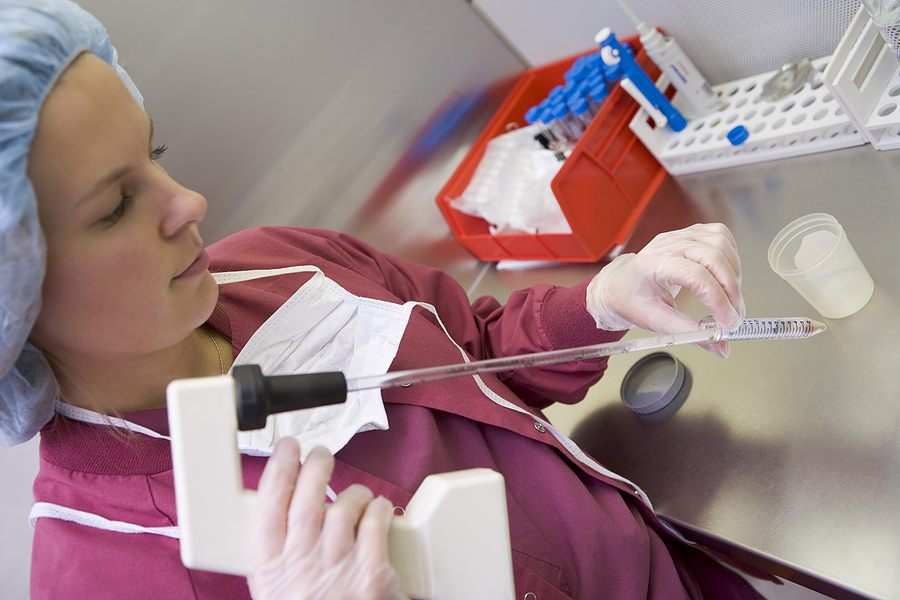 Lab technician performing IVF techniques with test tube