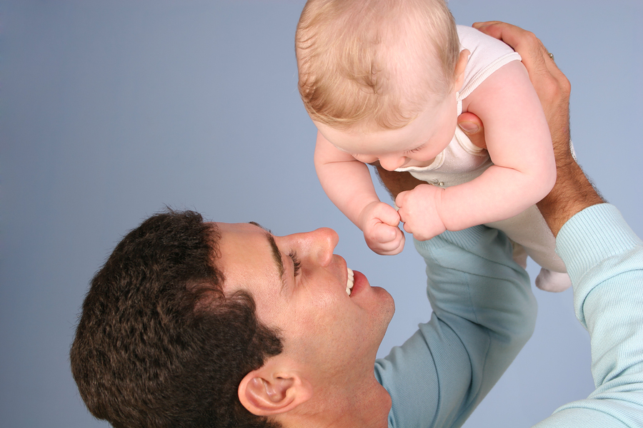 Caucasian brown hair known sperm donor holding is baby