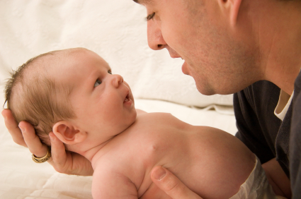 gay dad looking into babies eyes