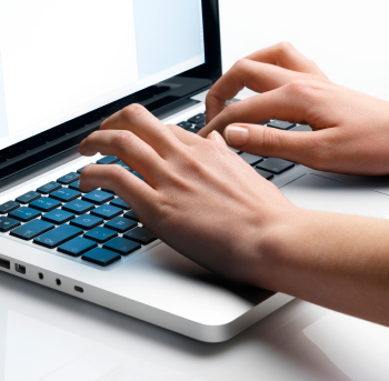 Hands on a laptop typing