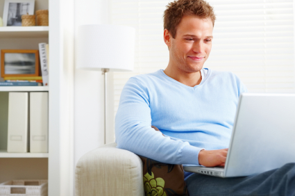 A sperm donor looking at laptop smiling