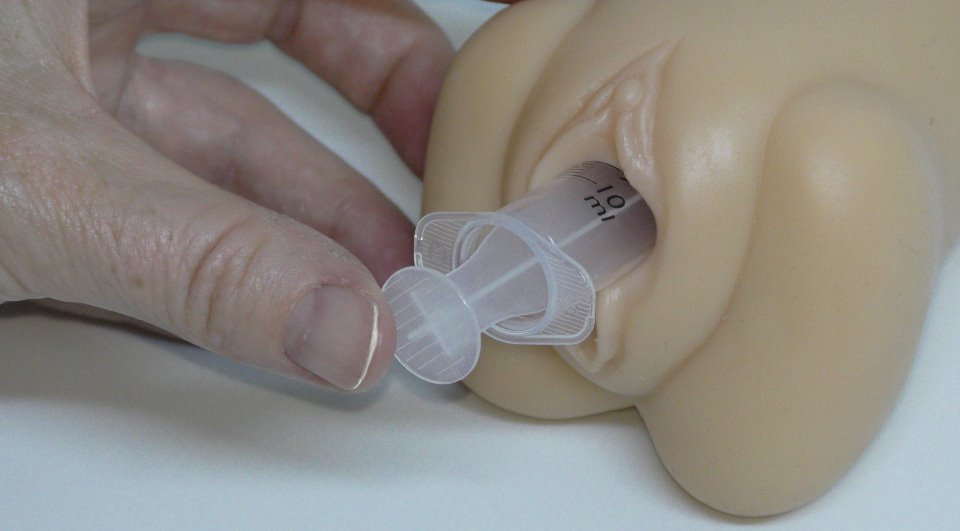 Syringe inserting sperm into vagina